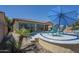 Well-manicured yard with a sparkling pool, lounge chairs, and mature palms at 3414 E Virgil Dr, Gilbert, AZ 85298