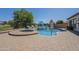 Beautiful backyard pool with umbrellas, lounge chairs, and mature landscaping for privacy at 3414 E Virgil Dr, Gilbert, AZ 85298