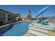 Backyard pool and spa with lounge chairs, and an umbrella, adjacent to the outdoor kitchen at 3414 E Virgil Dr, Gilbert, AZ 85298