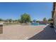 Stunning backyard pool area features lounge chairs, umbrella, and a well-maintained brick patio at 3414 E Virgil Dr, Gilbert, AZ 85298
