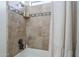 Close-up of a tiled shower with a shower head and built-in shelving at 3414 E Virgil Dr, Gilbert, AZ 85298