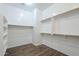 Large walk-in closet with ample storage space, wooden closet rods, and wood-look flooring at 3414 E Virgil Dr, Gilbert, AZ 85298