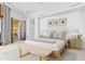 Bright bedroom featuring a neutral palette, woven bench, and stylish ensuite entrance at 5802 E Cholla Ln, Paradise Valley, AZ 85253