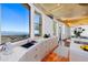 Modern kitchenette featuring sleek countertops, a sink, and expansive windows with city views at 5802 E Cholla Ln, Paradise Valley, AZ 85253