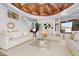 Spacious living room featuring neutral tones, modern art, and large windows for natural light at 5802 E Cholla Ln, Paradise Valley, AZ 85253