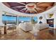Open living room featuring a decorative ceiling, large windows, and comfortable white sofas at 5802 E Cholla Ln, Paradise Valley, AZ 85253