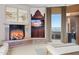 Comfortable main bedroom features a fireplace, decorative artwork, and scenic mountain views at 5802 E Cholla Ln, Paradise Valley, AZ 85253
