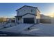 Modern two-story home with a sleek garage door and low-maintenance desert landscaping at 13245 N 19Th Way, Phoenix, AZ 85022