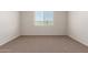 Bedroom with neutral carpet and a window that provides natural light at 18246 W Cielo Grande Ave, Surprise, AZ 85387
