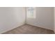 Bedroom with neutral carpet has a single window that provides natural light at 18246 W Cielo Grande Ave, Surprise, AZ 85387