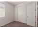 This bedroom features neutral carpet, light walls, and a closet for optimal storage at 18246 W Cielo Grande Ave, Surprise, AZ 85387