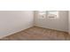 Bedroom features neutral carpet and a large window that offers nice views at 18246 W Cielo Grande Ave, Surprise, AZ 85387