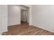 Clean, light-filled room with wood-look tile, neutral walls, and an open doorway at 18246 W Cielo Grande Ave, Surprise, AZ 85387