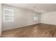 Bright room with wood-look tile flooring, neutral walls, and well-lit by multiple windows at 18246 W Cielo Grande Ave, Surprise, AZ 85387