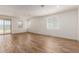 Large room with wood-look tile flooring, neutral walls, and multiple windows for ample light at 18246 W Cielo Grande Ave, Surprise, AZ 85387