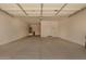Spacious garage with a light, painted floor, and ample room for parking and storage at 18246 W Cielo Grande Ave, Surprise, AZ 85387