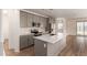 Modern kitchen featuring grey cabinets, stainless steel appliances, an island with a sink, and light countertops at 18246 W Cielo Grande Ave, Surprise, AZ 85387