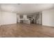 Open-concept living space showcasing the kitchen, wood-look tile flooring, and ample natural light at 18246 W Cielo Grande Ave, Surprise, AZ 85387
