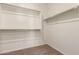Walk-in closet with carpet and white racks for hanging and organizing clothes at 18246 W Cielo Grande Ave, Surprise, AZ 85387