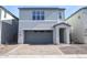 Charming two-story home featuring a brick driveway and a gray garage door at 2442 W Rowel Rd, Phoenix, AZ 85085