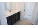 Bathroom featuring a white countertop, stylish dark cabinets, and modern fixtures at 2445 W Rowel Rd, Phoenix, AZ 85085
