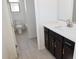 Bright bathroom featuring a white countertop, stylish dark cabinets, and modern fixtures at 2445 W Rowel Rd, Phoenix, AZ 85085