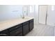 Modern bathroom featuring a dark wood vanity with double sinks, a large mirror, and a glass-enclosed shower at 2445 W Rowel Rd, Phoenix, AZ 85085