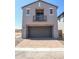 Modern home showcasing a gray exterior, balcony, brick-lined garage, and brick-paved driveway on a sunny day at 2445 W Rowel Rd, Phoenix, AZ 85085