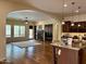 Open concept living space with fireplace, large windows, and seamless access from kitchen at 2717 W Nighthawk Way, Phoenix, AZ 85045