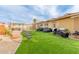 Wide view of the backyard with turf and outdoor furniture at 6908 W Sunnyside Dr, Peoria, AZ 85345