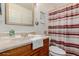 Simple bathroom with updated vanity and striped curtain at 6908 W Sunnyside Dr, Peoria, AZ 85345