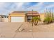 Tan house with solar panels and desert landscaping at 6908 W Sunnyside Dr, Peoria, AZ 85345