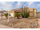 Inviting home exterior featuring desert landscaping, solar panels, and an attached garage at 6908 W Sunnyside Dr, Peoria, AZ 85345