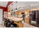 Bright kitchen featuring ample counter space, wood cabinets, stainless steel appliances, and bar stool seating at 6908 W Sunnyside Dr, Peoria, AZ 85345