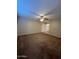 Unfurnished bedroom with ceiling fan and closet access at 10423 W Wheatridge Dr, Sun City, AZ 85373