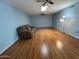 Open living room featuring hardwood floors and ample lighting at 10423 W Wheatridge Dr, Sun City, AZ 85373