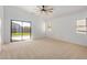 Bright bedroom with sliding glass door leading to backyard at 5411 W Grenadine Rd, Laveen, AZ 85339