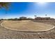 Landscaped common area with a grassy field and bordering homes visible at 5411 W Grenadine Rd, Laveen, AZ 85339