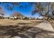 Concrete pathway winds through a neighborhood park with grassy areas and mature trees at 5411 W Grenadine Rd, Laveen, AZ 85339