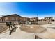 Circular seating area with metal benches and a trash can in a community park at 5411 W Grenadine Rd, Laveen, AZ 85339