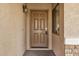 Front entry with a brown wood door and stone accents at 5411 W Grenadine Rd, Laveen, AZ 85339