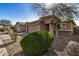 House exterior with a two-car garage and well-manicured shrubbery at 5411 W Grenadine Rd, Laveen, AZ 85339