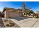 House exterior with a two-car garage and landscaping at 5411 W Grenadine Rd, Laveen, AZ 85339