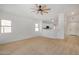 Bright living room with neutral carpeting and a ceiling fan at 5411 W Grenadine Rd, Laveen, AZ 85339