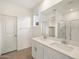 Bright bathroom featuring a double sink vanity, large mirror, and a glass-enclosed shower at 3175 E Hayden Rose Ave, San Tan Valley, AZ 85143