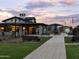 Exterior view of the community center, showcasing well-manicured landscaping and a walking path at 3175 E Hayden Rose Ave, San Tan Valley, AZ 85143