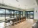 Elegant dining room with a long table, modern chandeliers, and sliding glass doors leading to a patio at 3175 E Hayden Rose Ave, San Tan Valley, AZ 85143