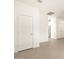 Hallway featuring neutral paint, tile floors, and door leading to the kitchen at 3175 E Hayden Rose Ave, San Tan Valley, AZ 85143