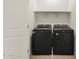 Modern laundry room features a black washer and dryer set with built-in shelving at 3175 E Hayden Rose Ave, San Tan Valley, AZ 85143