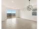 Bright living room with tile floors, modern lighting, and a sliding glass door to the backyard at 3175 E Hayden Rose Ave, San Tan Valley, AZ 85143